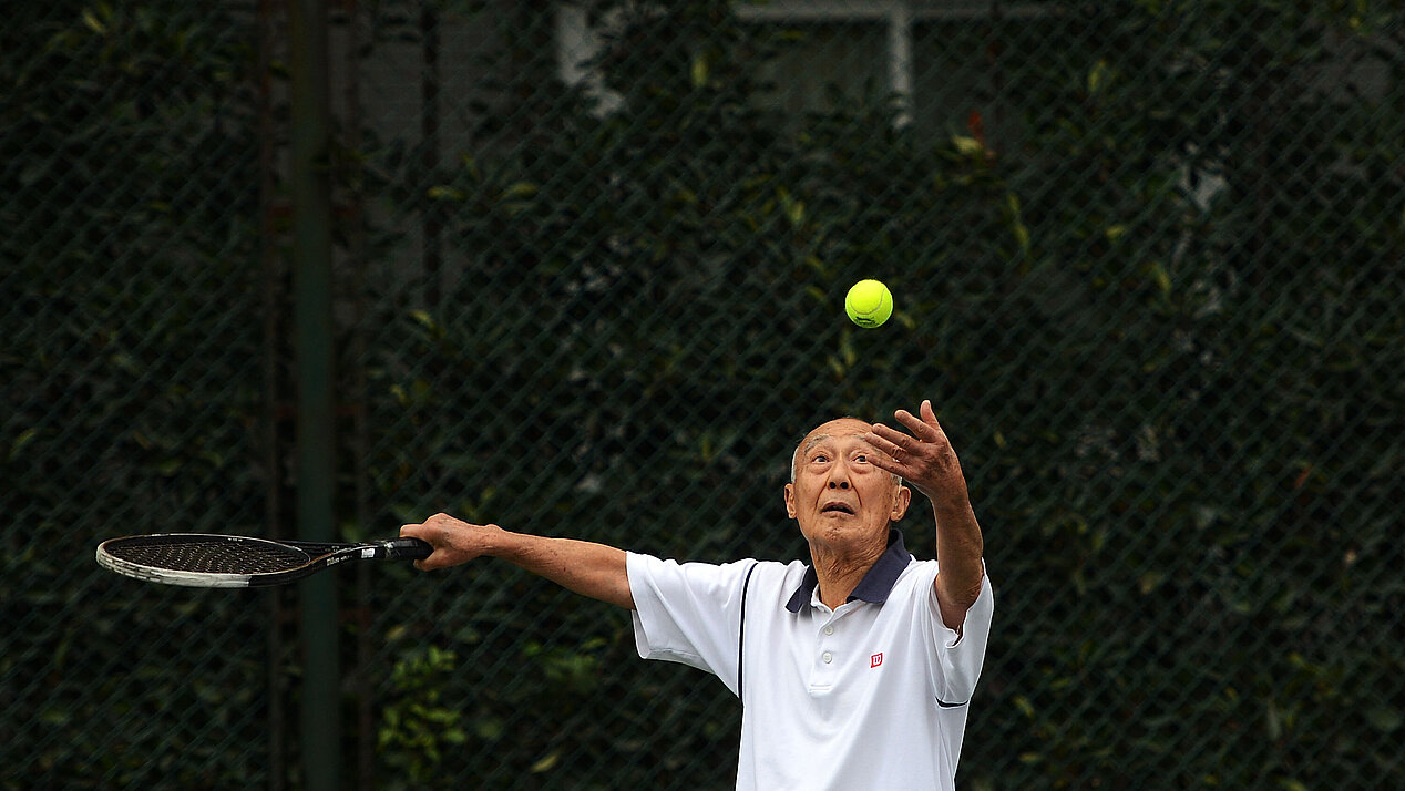 Old man playing tennis.